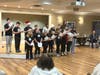 Natick Academy of Performing Arts entertain residents of Whitney Place during a holiday sing along performance.