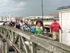 Ed Ferraro (right) leads the first group of visitors at the Ocean City Fishing Club's Open House at the Pier yesterday