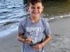 Luke Finnegan, 12, of Ocean City, shows off one of the kingfish he landed while fishing next to his buddy, Carter Linden, at the Ocean City Fishing Club's Boys and Girls Surf Fishing Tournament