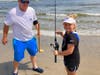 Ocean City Fishing Club member Bob Dever watches Colbie Aleszczyk, 9, of Delran, get ready to cast at the OCFC Boys and Girls Surf Fishing Tournament