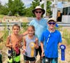 Ed Hoban, Ocean City Fishing Club's chairperson of the Boys and Girls Surf Fishing Tournament, stands with top anglers in the 8-10 years old category: Dean Teti, first place (right), Robert Simiraglio, second (left), and Julia Roman, third