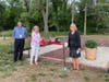 Principal George West and Business Administrator Dr. Diane Fox (right) with labyrinth creator and art teacher Karen Biederman as she cuts the ribbon