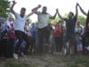Friends dancing in a circle formation. The men and women danced in separate circles to honor tradition.