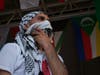 A Freedom Dabka Group dancer wipes his face after a performance.