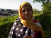 A girl draped in the American flag by the water on Shore Parkway.