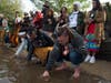At a water ceremony, members paid respect to natural bodies of water. Participants poured water from natural bodies of water they each collected from home to pour into the Harlem River.