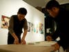 Gyatso Chuteng, an organizing committee member for Art for Tibet, left, prepared art for the exhibit with Dorjee Tseten, executive director of Students for a Free Tibet, right.