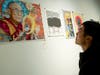 A visitor looked at “The Heart of His Holiness” by Jon Marro depicting the Dalai Lama. 