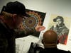 Visitors viewed “Chuck D Black Steel” by Shepard Fairey and Janette Beckman. 