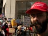A U.S. military veteran and Trump supporter (seen right) wore a "Make America Great Again" hat in front of Trump protestors (seen left) who demanded Trump's impeachment.