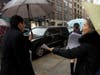 Nicole Izsak, right, a former Hong Kong resident, delivered flyers outlining the Uyghur struggle to conference attendees.