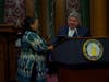 Brooklyn District Attorney Eric Gonzalez, right, shook hands with Gabrielle Prieto, left, a sex trafficking survivor. Gonzalez presented Prieto with a certificate honoring her efforts to combat human trafficking.