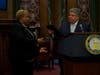 Brooklyn District Attorney Eric Gonzalez, right, shook hands with Beverly Smith, left, a labor trafficking survivor. Gonzalez presented Smith with a certificate honoring her efforts to combat human trafficking.