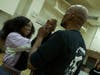 Derrick Strong, right, owner of Team Demolition Mixed Martial Arts gym, taught boxing self-defense techniques to 14-year-old, Myla Davis. Strong described moves for kids to defend themselves against child traffickers. 