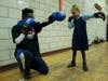Shane Haughton, left, showed 5-year-old Sayla Font, right, how to throw a jab. The workshop taught moves kids can use to defend themselves against child traffickers.