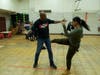 Derrick Strong, left, owner of Team Demolition Mixed Martial Arts gym, taught Jasmine Ray, director of Cornerstone Daycare Center, moves to defend herself from human traffickers. 
