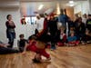 Bboy Kid Dynamite executed a headspin in the advanced level dance battle against bboy Quiet Storm standing behind him.