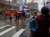 An onlooker, right, took a video of a group who was marching as part of the Chinese New Year parade. The group advocated freedom for Uyghurs being held in detention centers without due process in China.