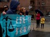 Parade spectators, right, watched from the sidewalk as a group calling for human rights for Uyghurs in China marched as part of the Chinese New Year parade.