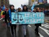 On Main Street, Flushing, dozens of Chinese flags lined both sides of the street as a group that was part of the Chinese New Year parade advocated for human rights for Uyghurs under the rule of the Chinese communist government in Xinjiang, China.