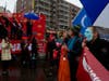 On Main Street, Flushing, marchers, right, who were part of the Chinese New Year parade called for human rights for Uyghurs in China. The marchers walked past a stage where revelers were celebrating the Chinese New Year.