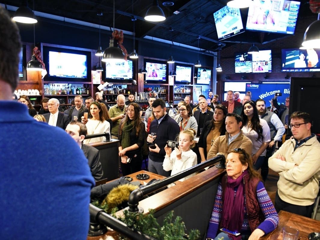 The crowd Dec. 30 watched as Gov. Chris Sununu placed the Granite State’s ceremonial first legal sports wager on the New England Patriots to win the Super Bowl at Shoppers Pub + Eatery at Indian Head in Manchester on Monday.