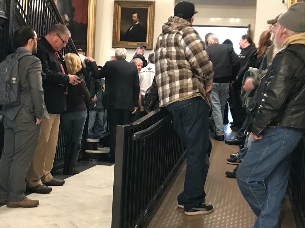 People line up to register to speak or register their position on House Bill 1621, which would mandate the use of helmets for riders and operators of motorcycles, mopeds and motorized scooters.