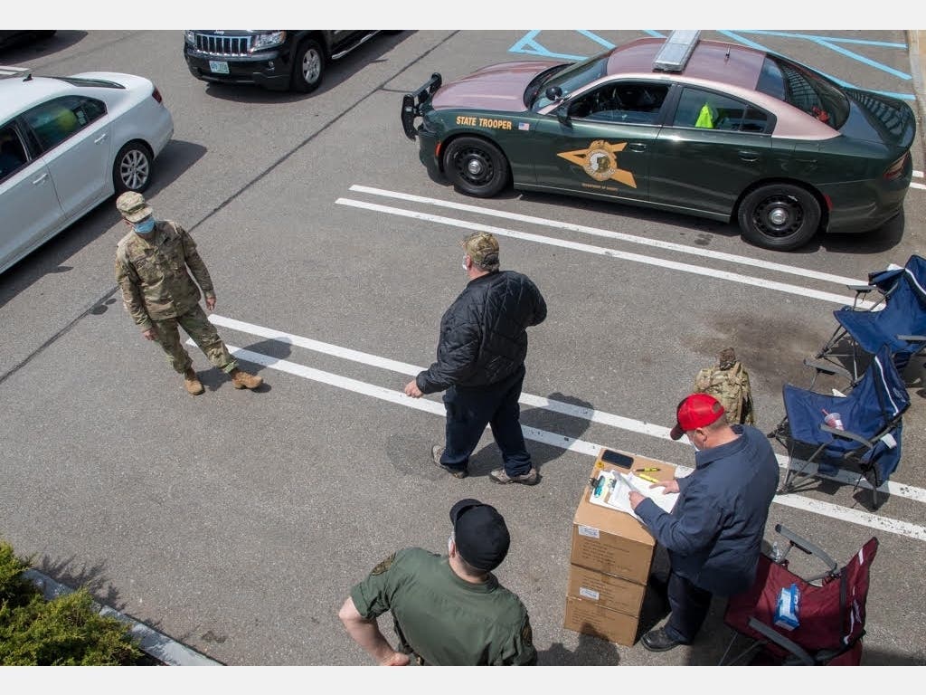 Businesses picked up PPE from the state Friday at the Manchester DMV to prepare to reopen on Monday.