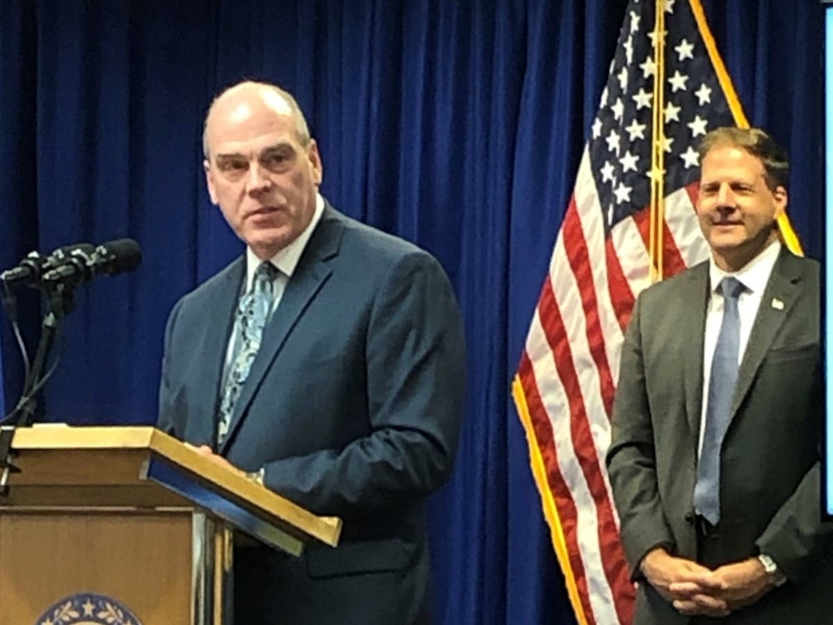 Assistant Safety Commissioner Perry Plummer is pictured at the podium Tuesday with Gov. Chris Sununu in the background. Plummer is retiring after 34 years.
