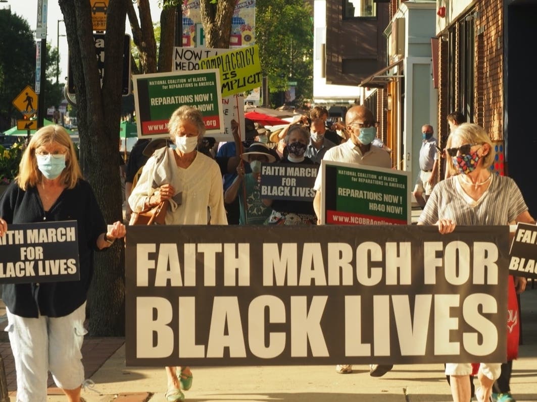 About 100 people marched in Manchester Saturday to end racism.