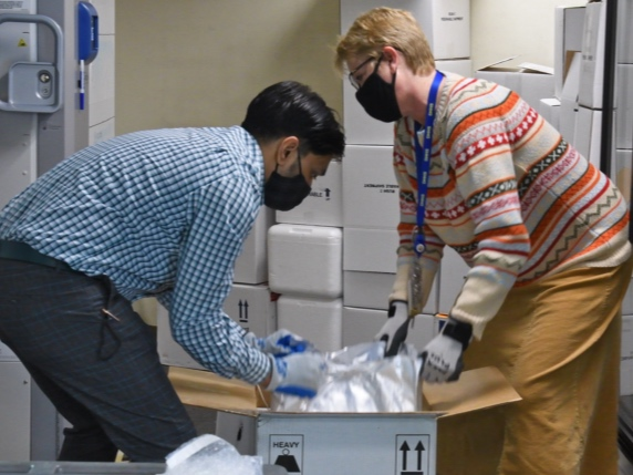 Unidentified workers unpack the first doses of the COVID-19 vaccine that arrived at an undisclosed location in New Hampshire on Dec. 14, 2020 in this file photo.