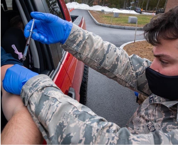 Department of Public Health photo of the vaccine being given at a drive-thru station.