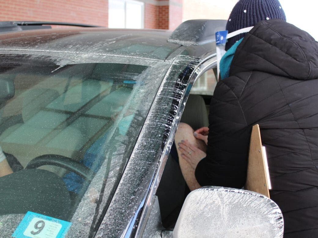 Vaccinating driver in Littleton in February.