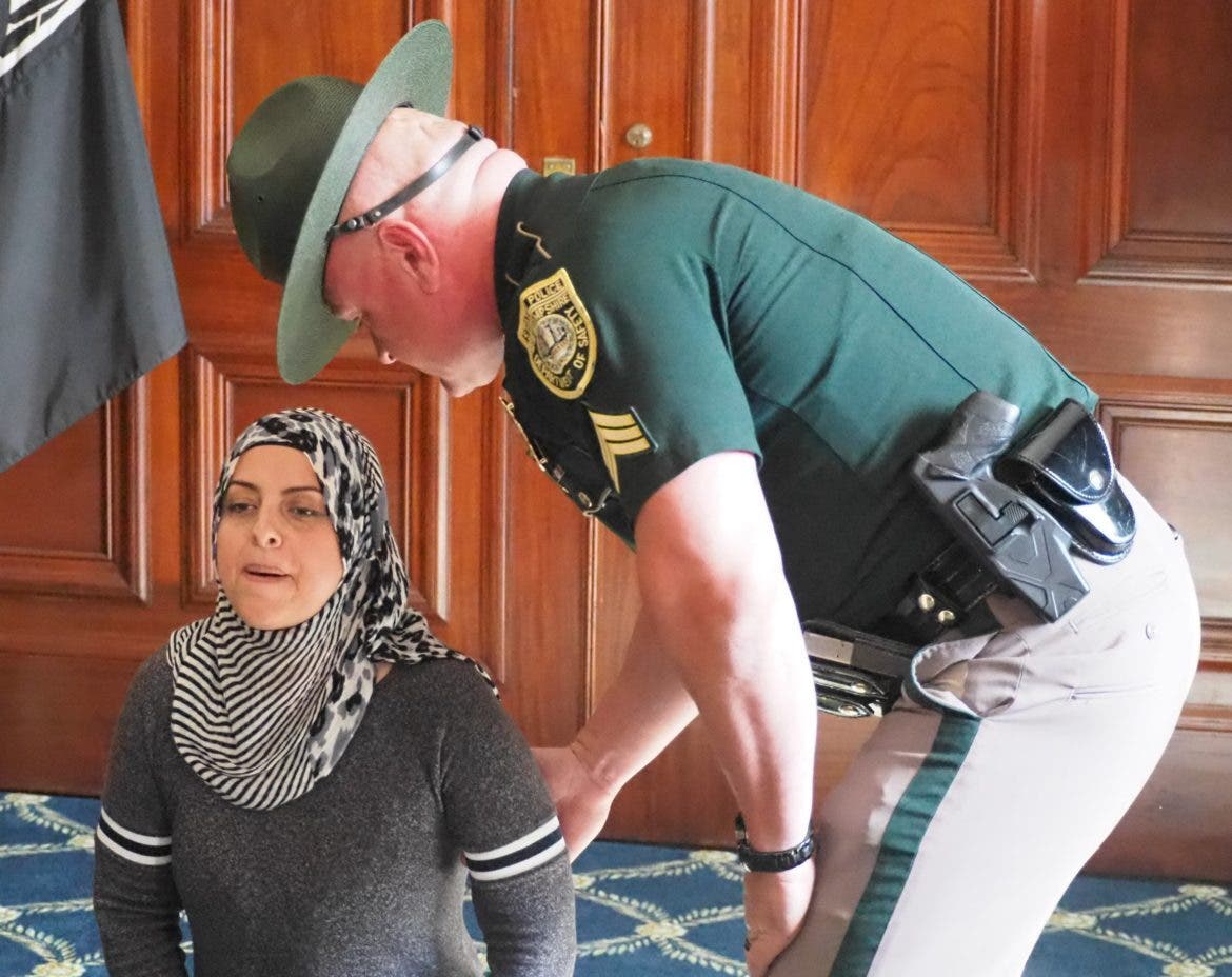 State Police arrest Asma Elhuni at the State House Thursday when she and four others refused to leave at 5 p.m.