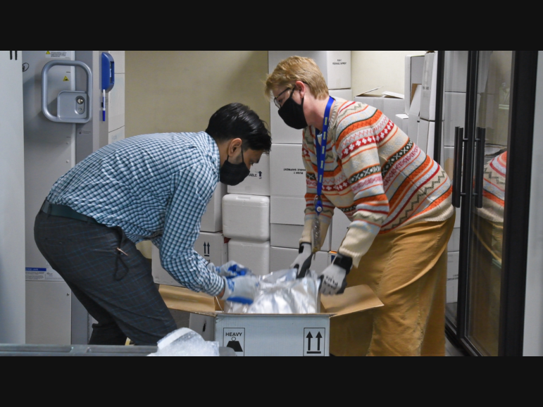 Unidentified workers unpack the first doses of the COVID-19 vaccine that arrived at an undisclosed location in New Hampshire on Dec. 14, 2020 in this file photo.