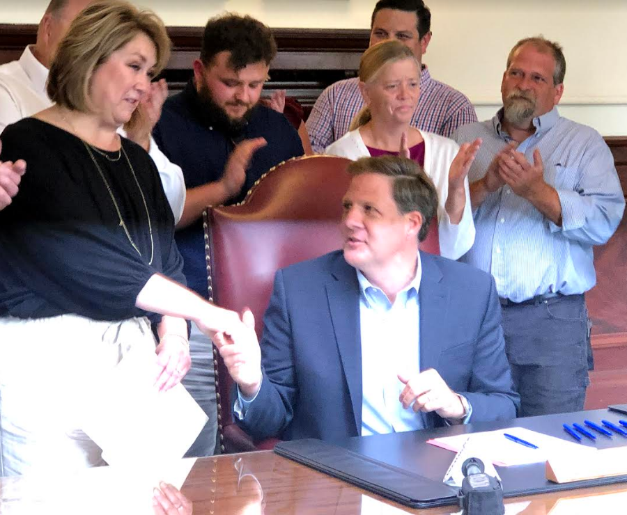 Tyler Shaw's mother, Beth Shaw, shakes Gov. Chris Sununu's hand Monday after he signed a law she pushed for enhancing penalties for drunk drivers.