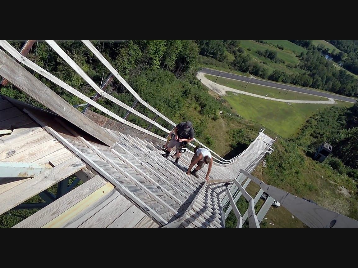 A crew from Knollson Contracting makes repairs to the Big Nansen Ski Jump in Milan. (WeRmudfun video screenshot)