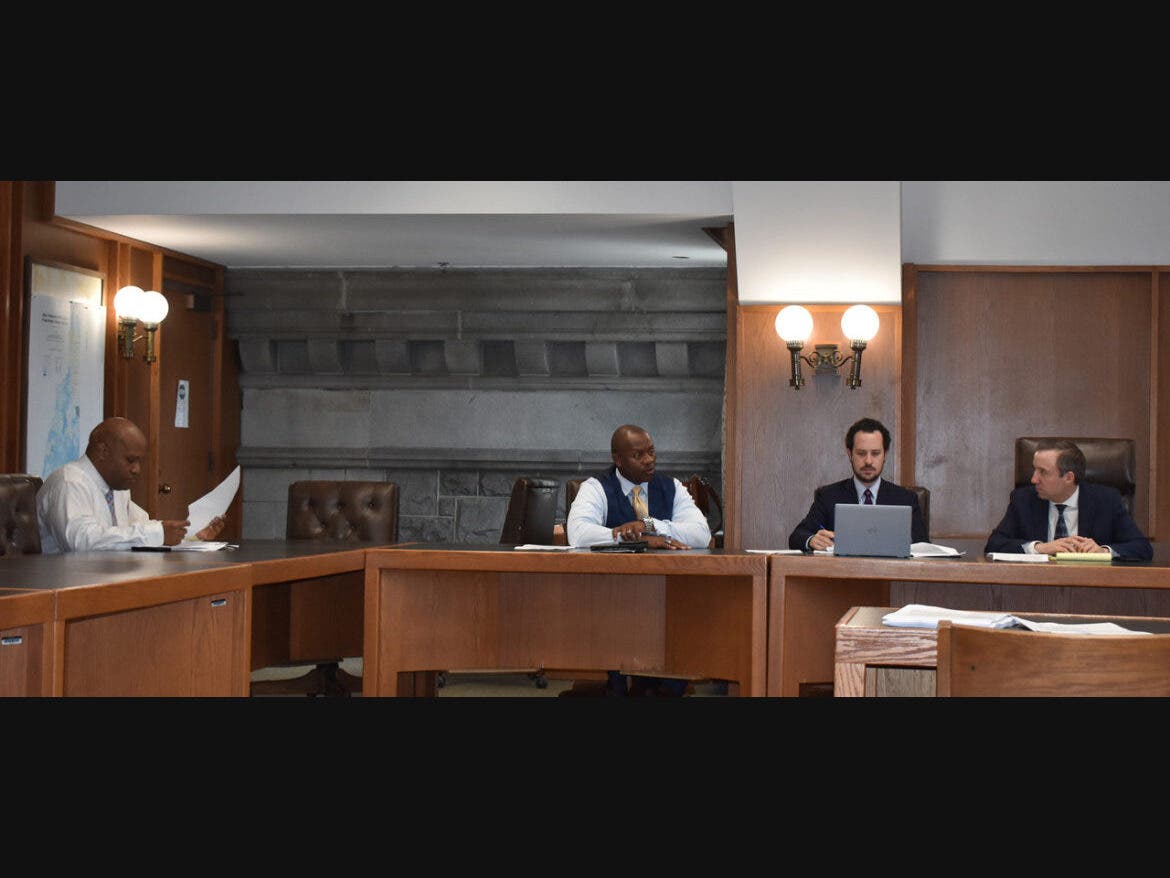Attorney Julian Jefferson, Assistant Safety Commissioner Eddie Edwards, Sr. Asst. Attorney General Matthew Broadhead, and Attorney General John Formella prepare for the Oct. 14 meeting of the commission on officer misconduct in Concord.