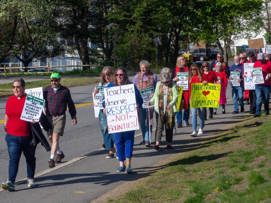 Rev. Heidi Heath of the NH Council of Churches leads march for public education in Durham Thursday.