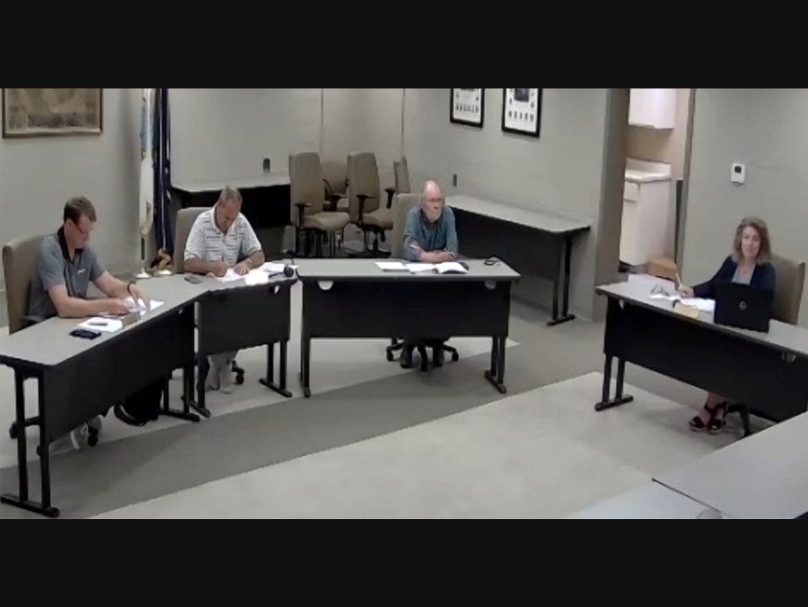 Belknap County Commissioners (from left) Glen Waring, Peter Spanos, and Hunter Taylor, along with County Administrator Debra Shackett, discuss the request for payment of legal bills incurred during the Belknap County Delegation’s defense on June 6.