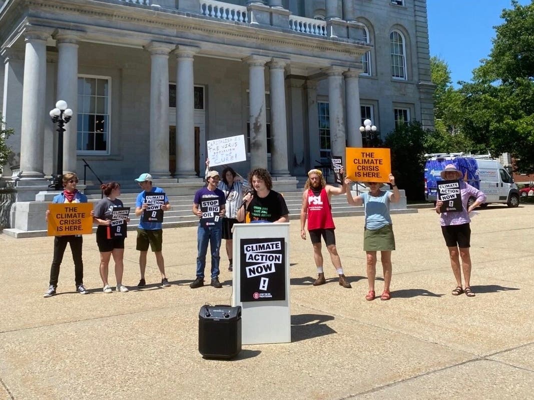 Members of 350 NH Action rally on State House lawn Thursday.