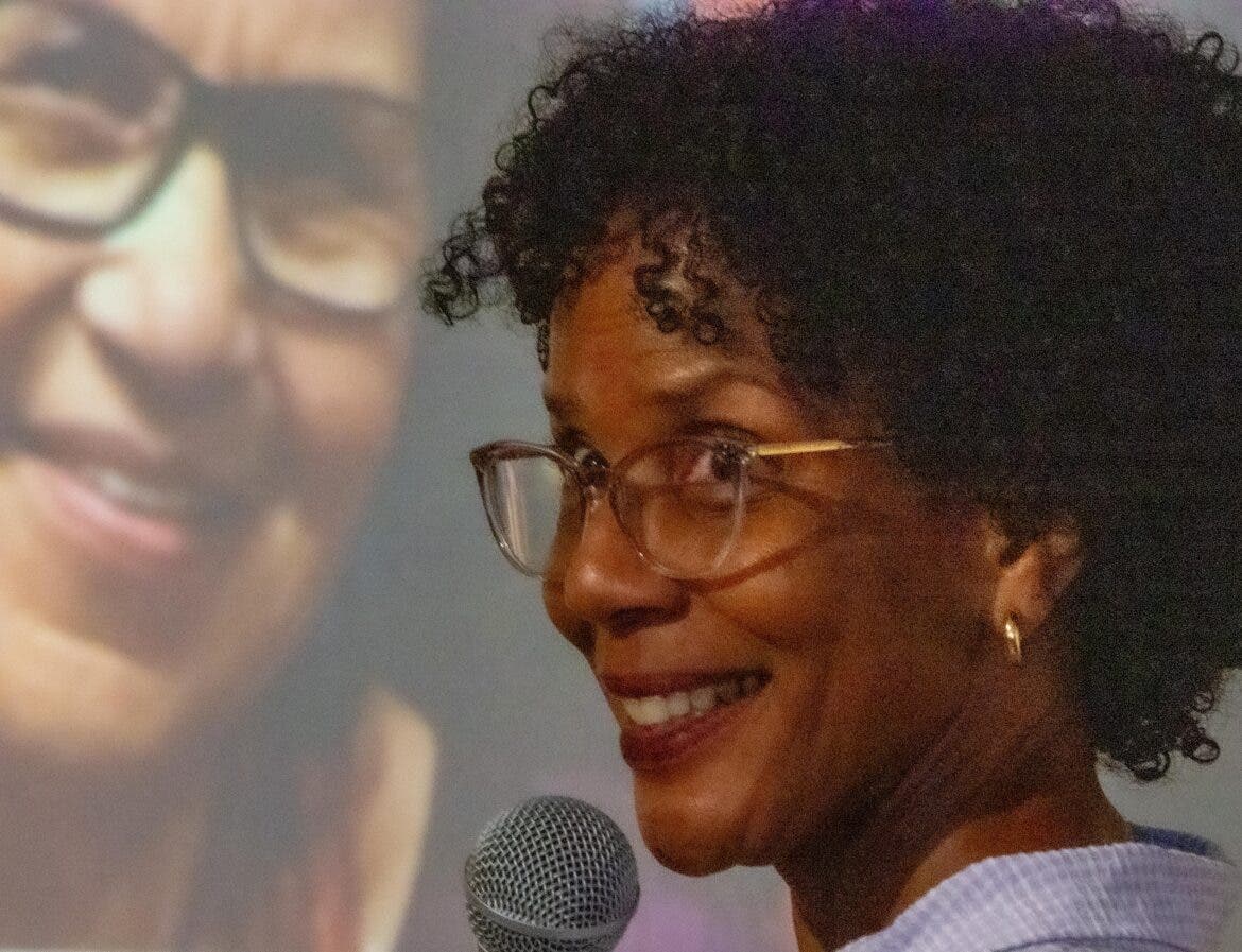 Kirby Randolph with her mother Valerie Cunningham projected behind her at the 30th anniversary of the Black Heritage Trail in Portsmouth. celebration Thursday that honored Cunningham.
