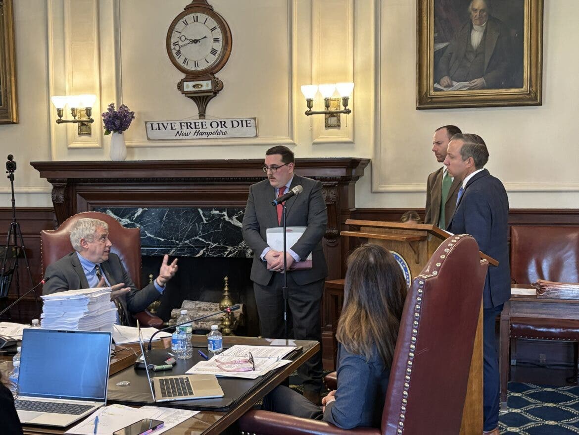 Councilor Joe Kenney talks with Adam Crepeau, interim commissioner for the Department of Natural and Cultural Resources, Governor's Legal Counsel Myles Matteson, AG John Formella and Gov. Kelly Ayotte about the Connecticut Lakes Headwaters Wednesday.