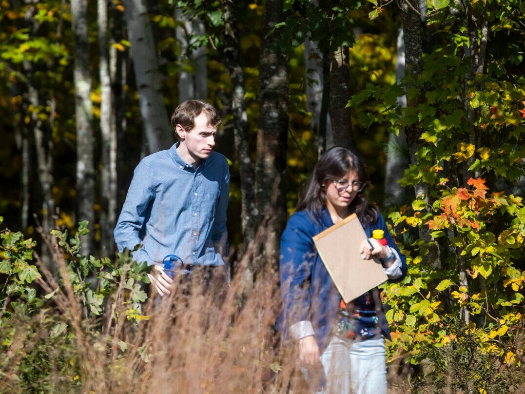 Logan Clegg walks along the Marsh Loop Trail with defense attorney Maya Dominguez during the view during the first day of his trial in Concord on Oct 3, 2023. Clegg was convicted of the shooting deaths of Steve and Wendy Reid in April 2022.