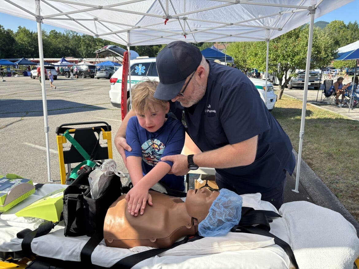 Ryan Robertson of Ashland, Mass. tries CPR with Linwood Ambulance Chief Jon Boufford teaching
