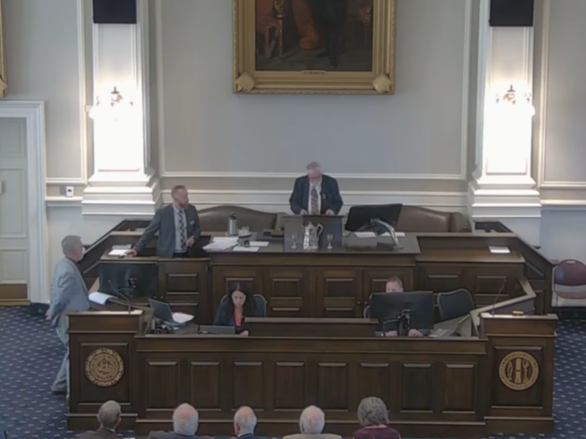 Rep. James Spillane, R-Deerfield, stands in the well at left, as he is censured by the House Wednesday for defamatory and demeaning remarks he made about fellow lawmakers.