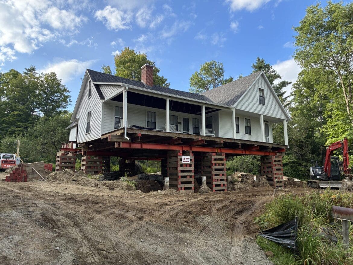 Robert Frost home in Franconia. Frost’s former home has been temporarily lifted high into the air, allowing crews to remove the existing cellar and construct a new, watertight foundation.