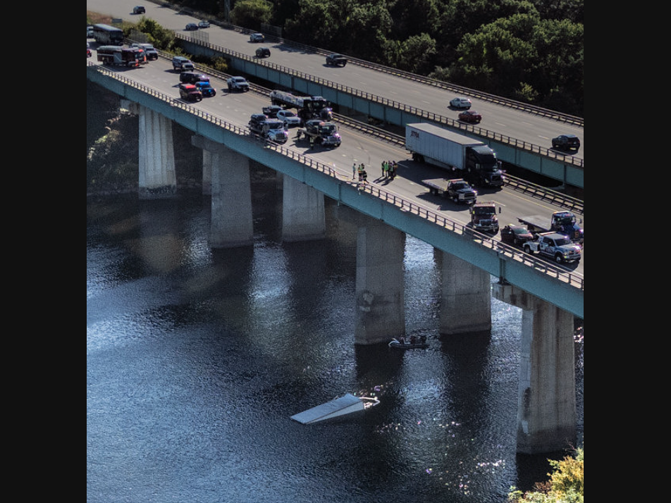 Box truck that broke through the guardrail on the bridge and fell into the Merrimack River on I-293 northbound in Manchester Wednesday.
