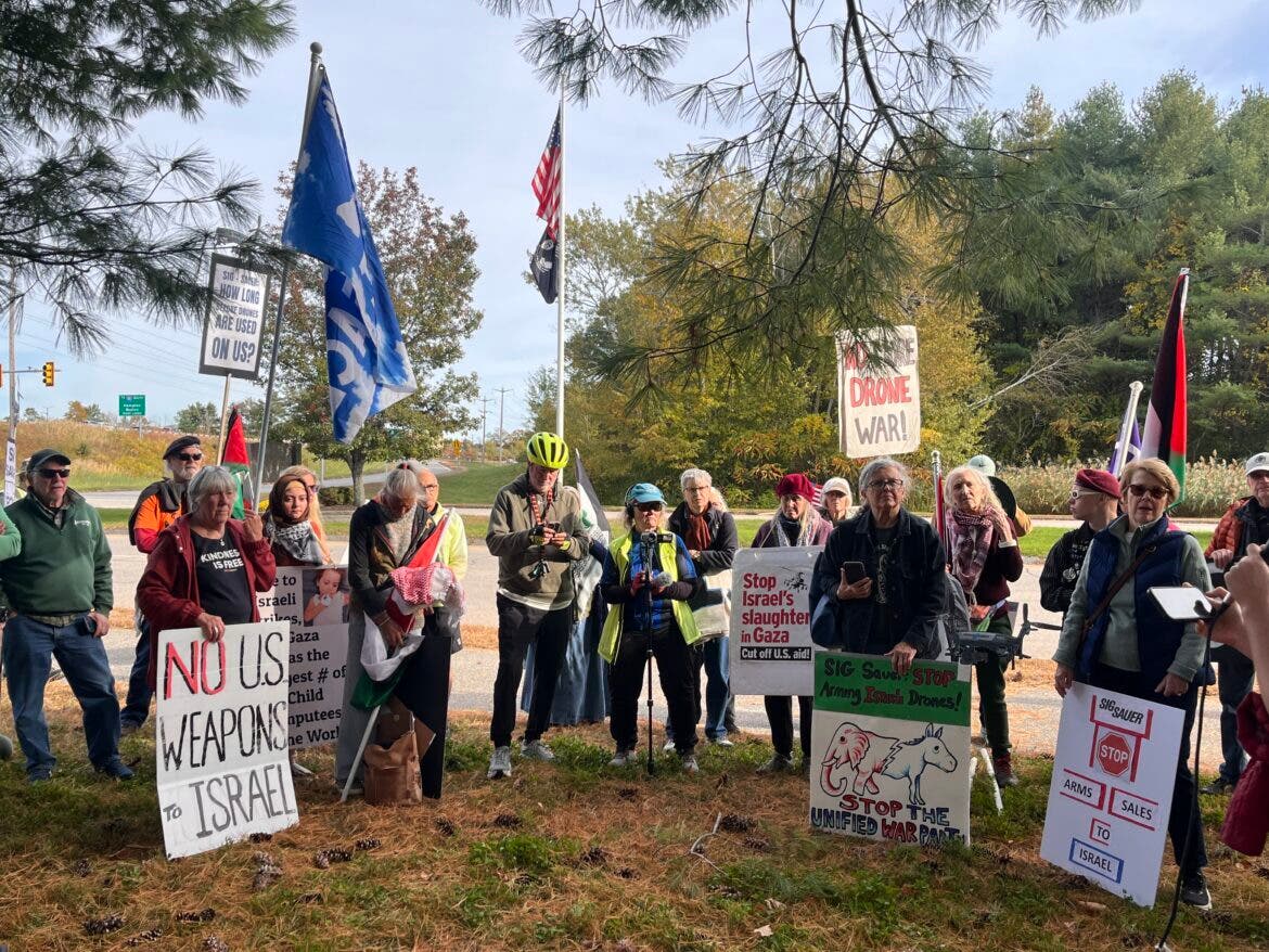 Dozens of protestors gather down the road from Sig Sauer’s headquarters in Newington on Saturday to oppose the company supplying arms to Israel.