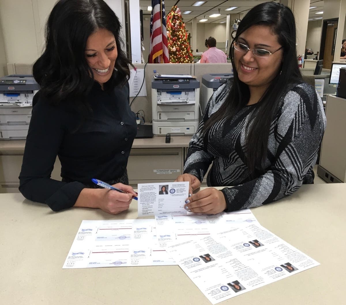 Will County Clerk Lauren Staley Ferry reviews redesigned Voter Registration Cards with staff member Tanya Arias from her Voter Registration Department.